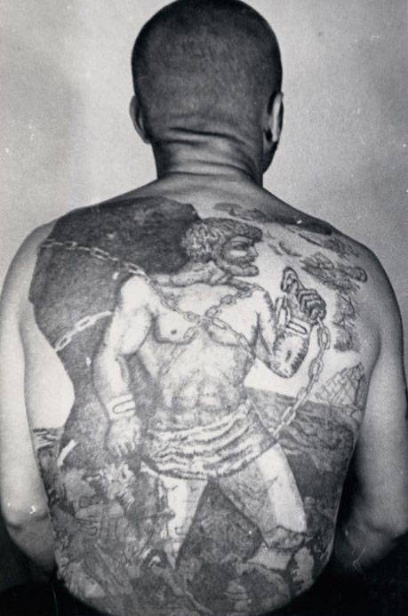 This tattoo is a variation on the myth of Pometheus, who, after tricking Zeus, is chained to a rock in eternal punishment. The sailing ship with white sails means the bearer does not engage in normal work; he is a traveling thief prone to escape.