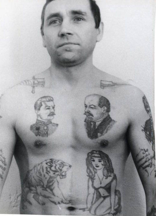 Text on the arm reads ‘Thank you Dear Motherland for my ruined youth.’ A dagger through the neck shows that a criminal has committed murder in prison and is available to hire for further killing. The drops of blood can signify the number of murders committed. Lenin is held by many criminals to be the chief ‘pakhan’ (boss) of the Communist Party. The letters BOP, which are sometimes tattooed under his image, carry a double meaning: The acronym stands for ‘Leader of the October Revolution’ but also spells the Russian word ‘VOR’ (thief).