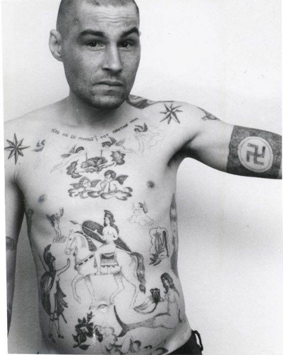 Text across the chest reads ‘He who is not with me is against me.’ The swastika and Nazi symbols may mean the owner has fascist sympathies, though they are more usually made as a protest and display of aggression toward the prison or camp administration. During the Soviet period the authorities often removed these tattoos by force either surgically or by using an etching method. A tattoo of a mermaid can indicate a sentence for rape of a minor, or child molestation. In prison jargon the nickname for a person who commits this type of crime is ‘amurik,’ meaning ‘cupid’, ‘shaggy,’ or a universal ‘all rounder.’ They are ‘lowered’ in status by being forcibly sodomised by other prisoners, sometimes in groups.