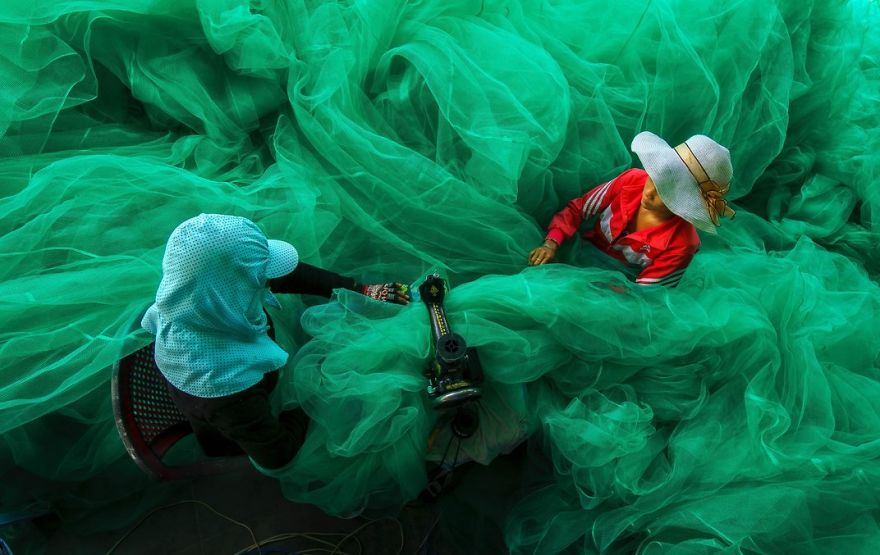 Women Of A Small Village Near Vinh Hy Bay, Vietnam, Sew A Fishing Net While Their Husbands Fish. Vinh Hy Bay, Ninh Thuan, Vietnam