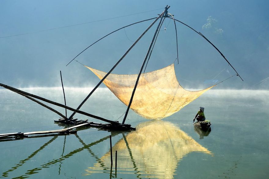A Fisherman Checks His Net In The Early Morning. Lam Dong, Dalat, Vietnam