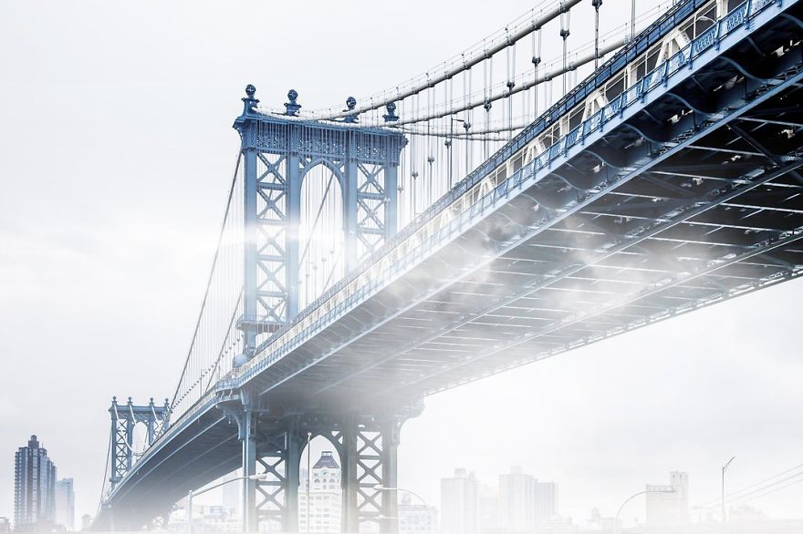 Fog Creeps Under The Manhattan Bridge. New York, New York