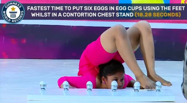 thigh - Jinnes Fastest Time To Put Six Eggs In Egg Cups Using The Feet Whilst In A Contortion Chest Stand 18.28 Seconds