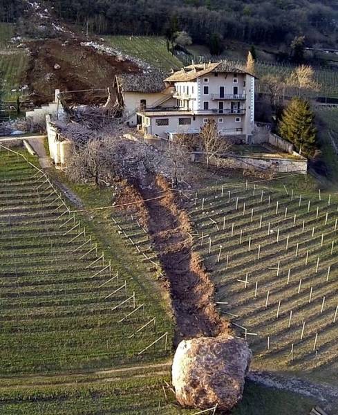 “Close call: Boulder nearly takes out Italian farm house.”