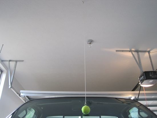 Use a tennis ball on a string to park in a garage tight for space - 
If you are anything like me then your garage is not only the place where you keep your car. It is also the place where the lawn mower, the garbage bin, gardening tools and anything else that you use outside on a regular basis lives. Thus space becomes precious real estate and it becomes a tighter fit, especially for your car. Well, if you need to remember just where to park without scraping or damaging any of your things, this is a great life tip.