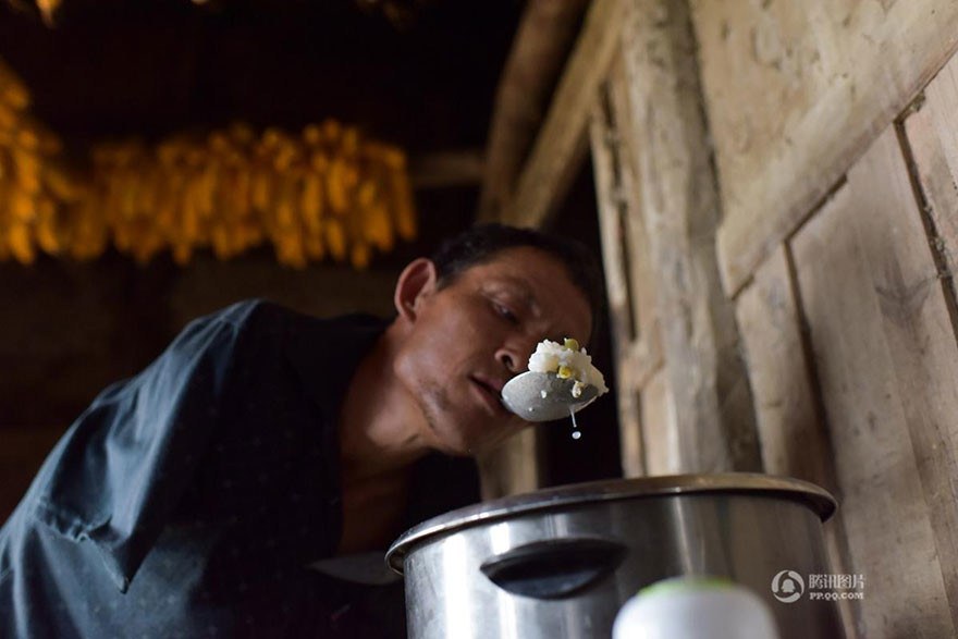 Chen takes care of his 91-year-old mother full time, and feeds her with a spoon between his teeth. They live in Chongqing, in south-west China.