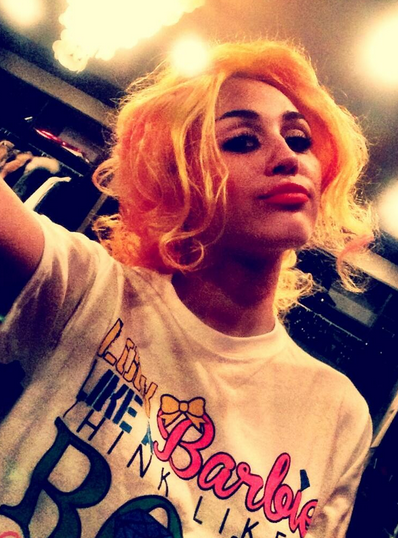 Between the red lips and yellow wig, we don't know what Miley was thinking