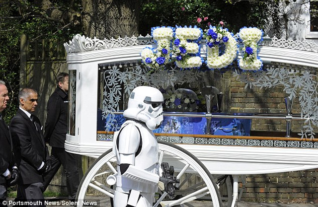 His carriage was covered with floral tributes, including one reading "Jedi" and wreaths in the shape of a lightsaber, Yoda and R2-D2. Fellow Star Wars lovers who heard about the boys wish came dressed as Stormtroopers to give him a guard of honor.