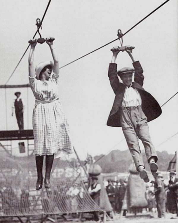 A couple enjoys an old-fashioned zipline at a fair - 1923.