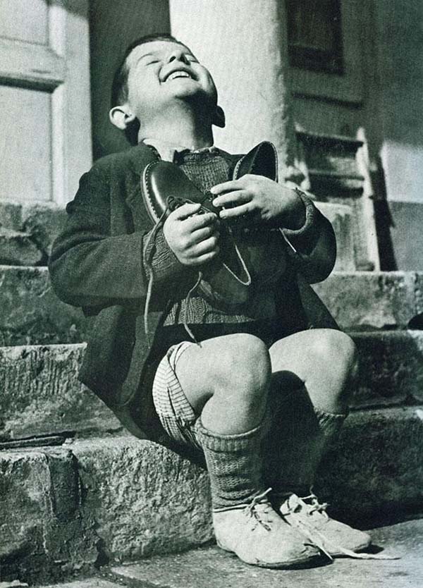 An Austrian boy is excited about his first pair of new shoes in years - 1946.