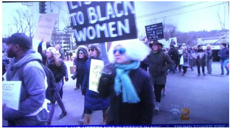 Black women holding signs