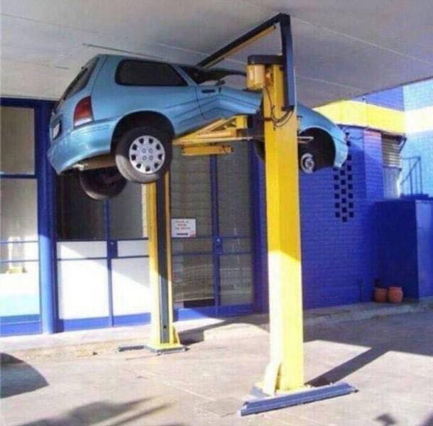 Car lift that may have lifted too much and squashed the car against the ceiling