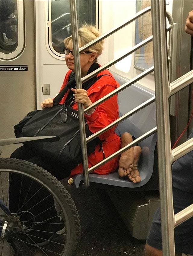 feet on subway - not lean on door