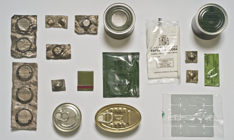 The Spanish lunch pack has cans of green beans with ham, squid in vegetable oil, and pate. There is also a sachet of powdered vegetable soup, peach in syrup for dessert and crackers handed out to go with the meal in place of bread not shown. There is a disposable heater with matches and fuel tabs, as well as lots of tablets: Vitamin C, glucose, water purification, and rehydration.
