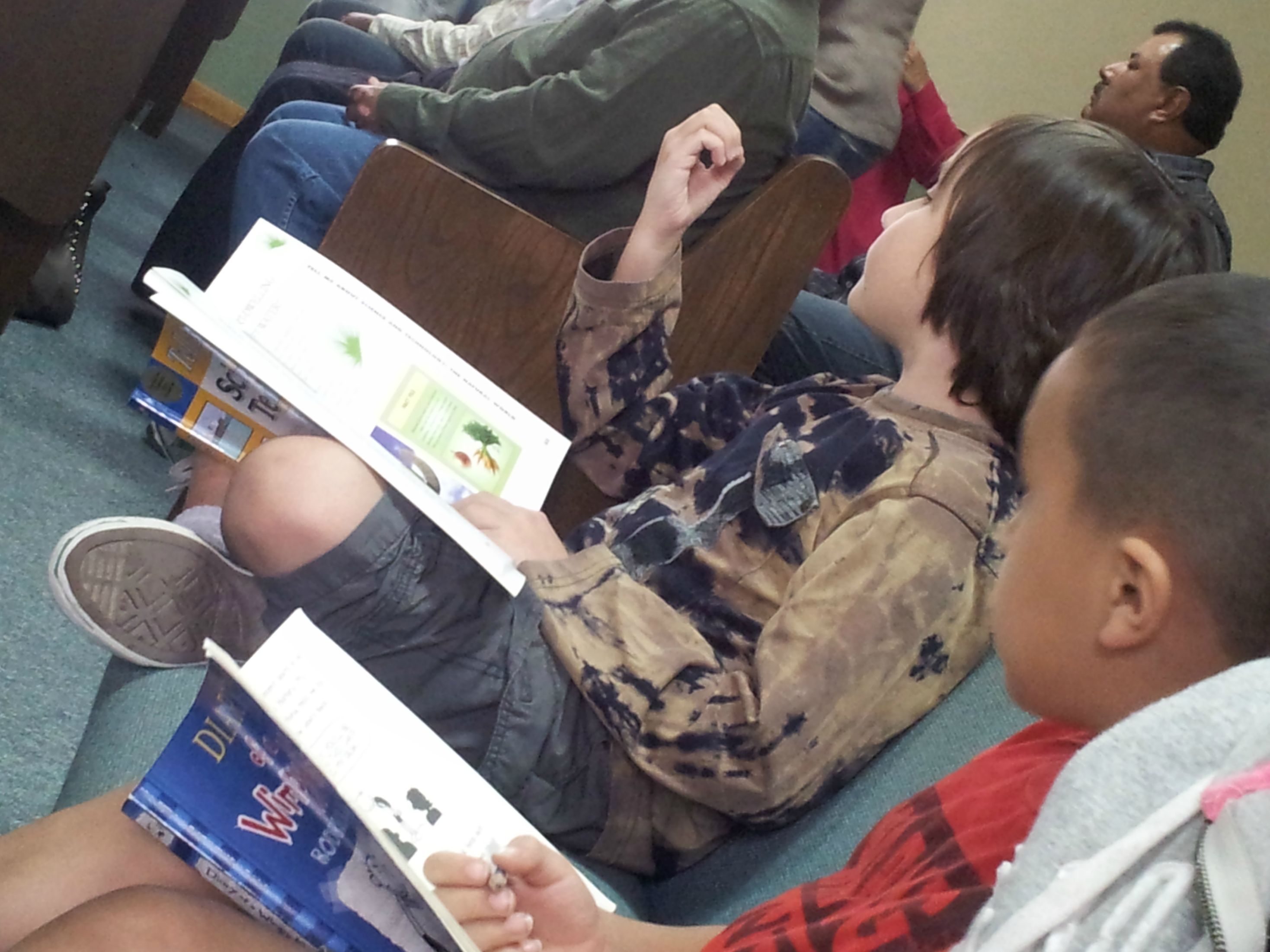 The kid who is obviously bored in church just happens to be reading a Science and Technology textbook.