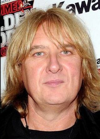 Joe Elliott. Lead singer of Def Leppard. Ugly man trying to look like woman or vice versa? He could pass as an older version of lesbian Mary Cheney.