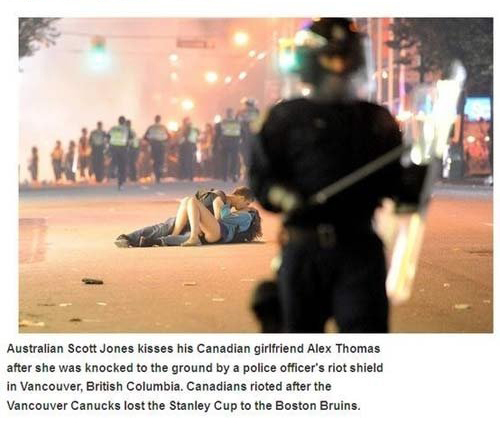 vancouver riot kiss meme - Australian Scott Jones kisses his Canadian girlfriend Alex Thomas after she was knocked to the ground by a police officer's riot shield in Vancouver, British Columbia, Canadians rioted after the Vancouver Canucks lost the Stanle