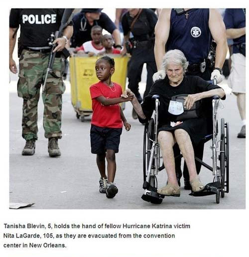 iconic hurricane katrina - Police Tanisha Blevin, 5, holds the hand of fellow Hurricane Katrina victim Nita LaGarde, 105, as they are evacuated from the convention center in New Orleans.