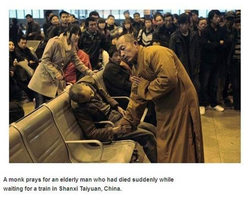 monk prays for dead man - A monk prays for an elderly man who had died suddenly while waiting for a train in Shanxi Taiyuan, China.