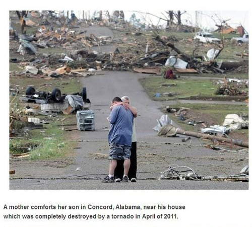 alabama tornado 2011 - A mother comforts her son in Concord, Alabama, near his house which was completely destroyed by a tornado in April of 2011.