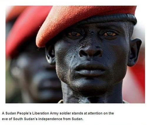 dark south sudan people - A Sudan People's Liberation Army soldier stands at attention on the eve of South Sudan's independence from Sudan.