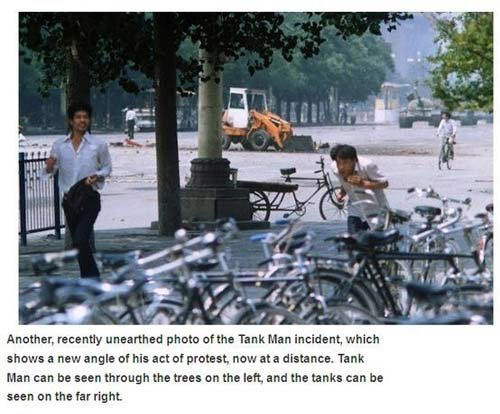 tiananmen square tank man terril jones - Another, recently unearthed photo of the Tank Man incident, which shows a new angle of his act of protest, now at a distance. Tank Man can be seen through the trees on the left, and the tanks can be seen on the far