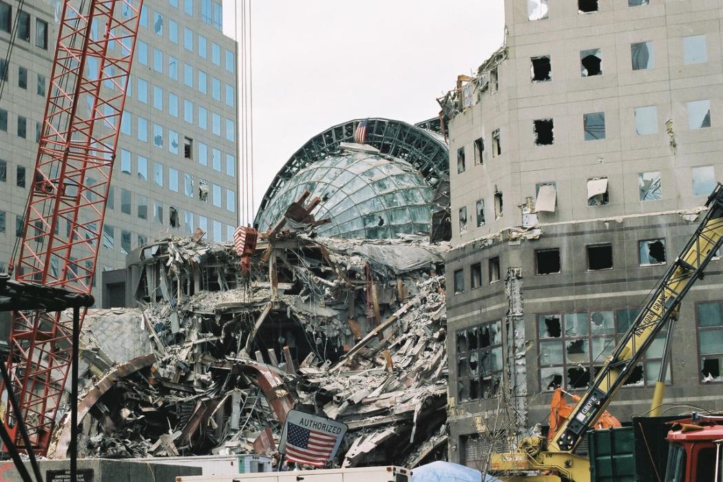 Broken windows in the vaulted roof of the Winter Garden, left, and the smashed facade of World Financial Center following the collapse of the World Trade Center, Sept. 27, 2001