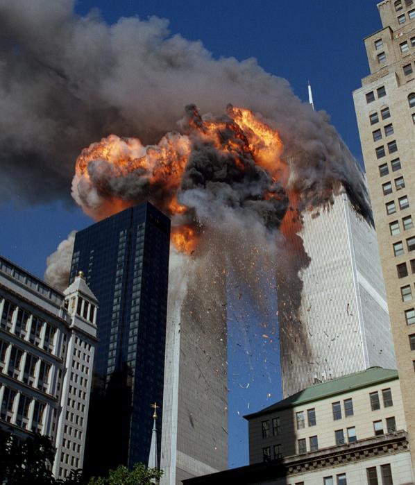 Smoke, flames and debris erupt from one of the World Trade Center towers as a plane strikes it on Sept. 11, 2001. The first tower was already burning following a terror attack minutes earlier. Terrorists crashed planes into the two buildings and collapsed both towers