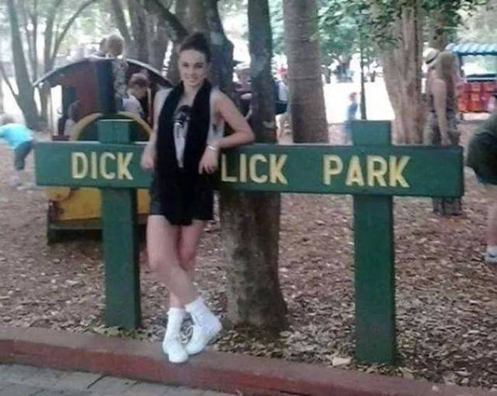 Girl blocking sign so it reads welcome to dick lick park