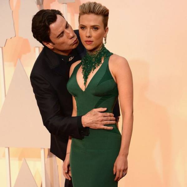 funny and creepy picture of John Travolta sneaking in a side kiss to Scarlett Johansson