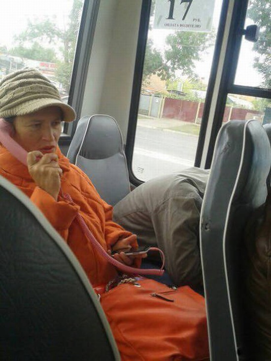 funny picture of hipster that appears to be on a phone with a cord on a bus
