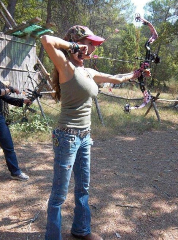 Girl at a firing range with a bow and arrow.