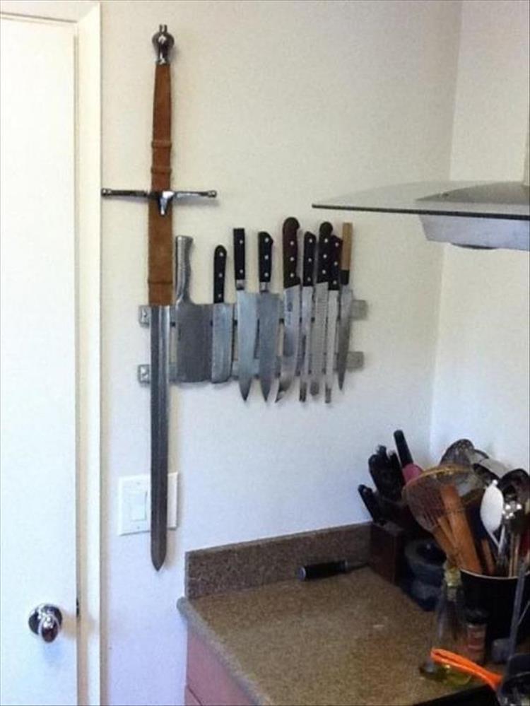 Knife arrangement in the kitchen and one of the knives is a huge sword.