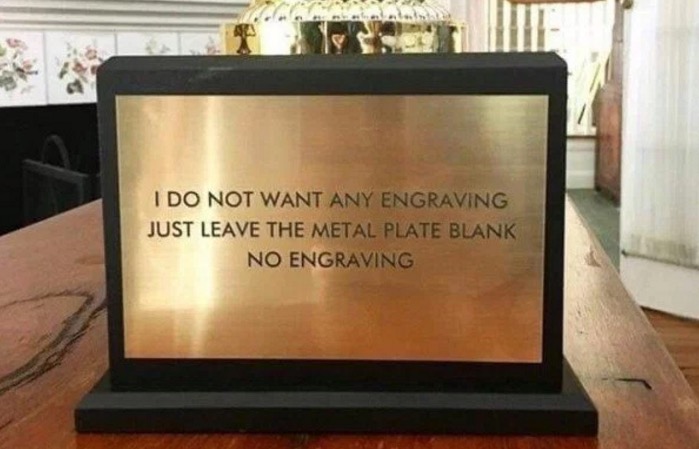 Metal plate trophy that was supposed to be blank, but instead the engraved it with the words of the instructions to keep it blank.