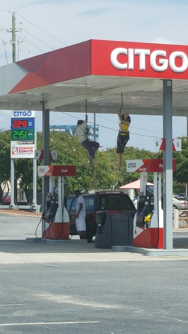 People climbing the Citgo gas station