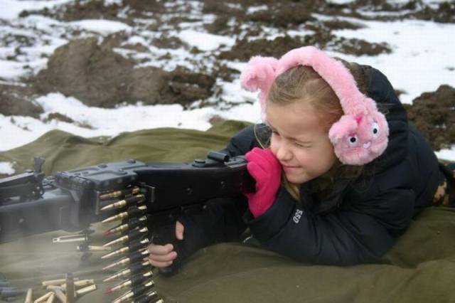 little girl shooting a gun