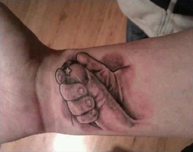 double take baby holding finger tattoo