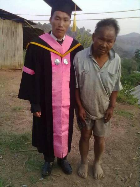 A proud son taking a photo with his proud, but tired, dad.