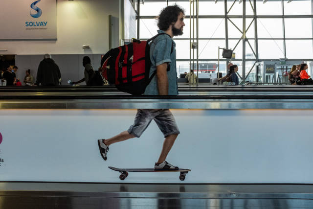 perfect timing of person taking moving platform with picture of skateboard coupled at just the right moment