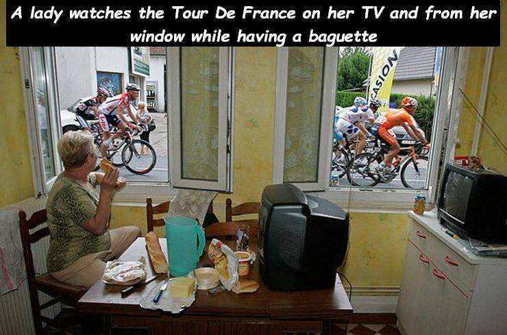 bicycle - A lady watches the Tour De France on her Tv and from her window while having a baguette Casion Bu