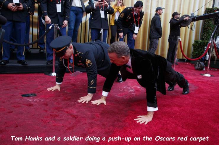 Tom Hanks - Tom Hanks and a soldier doing a pushup on the Oscars red carpet