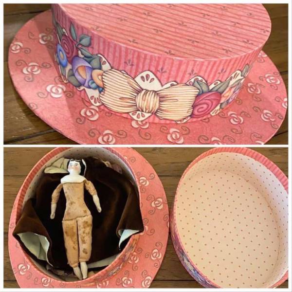 pink hatbox with doll inside