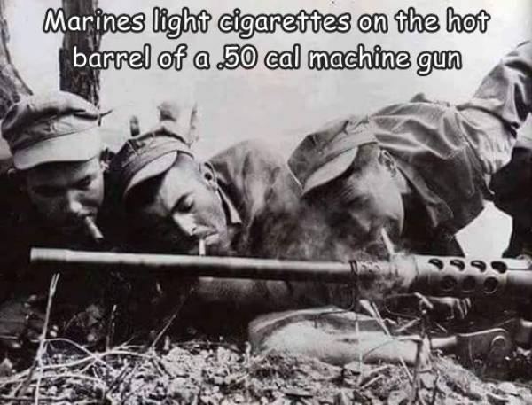 Marines light cigarettes on the hot barrel of a 50 cal machine gun