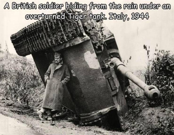 fresh randoms - broken tiger tank - A British soldier hiding from the rain under an overturned Tiger tank. Italy, 1944