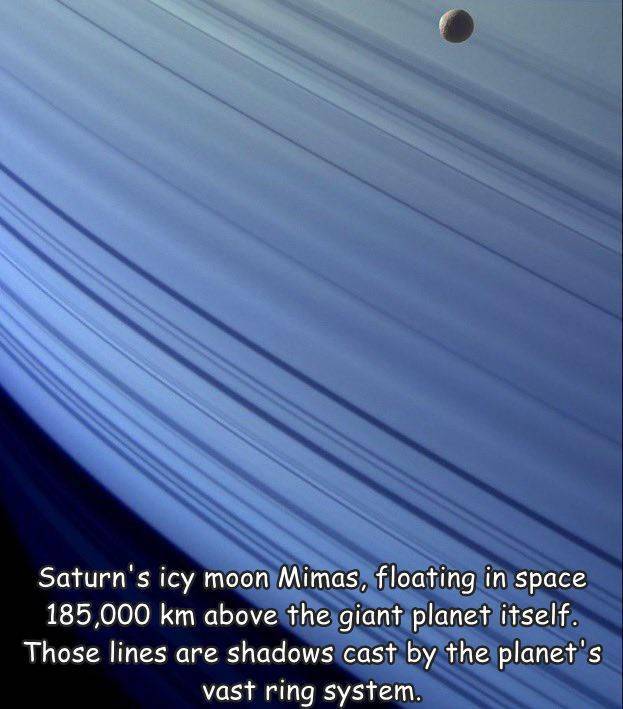 fun randoms - sky - Saturn's icy moon Mimas, floating in space 185,000 km above the giant planet itself. Those lines are shadows cast by the planet's vast ring system.
