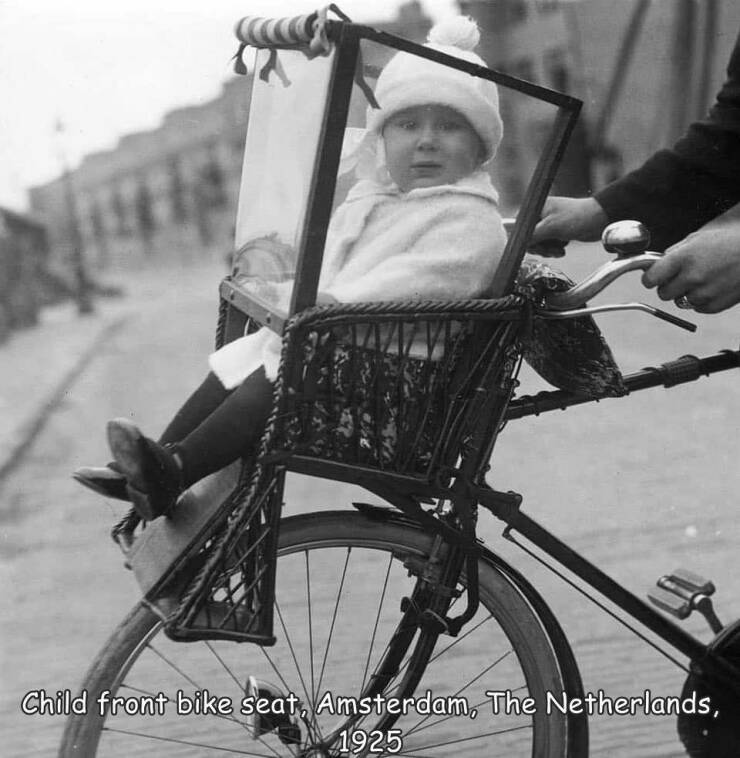fun randoms - funny photos - carrier in old cycle - Child front bike seat, Amsterdam, The Netherlands, 1925