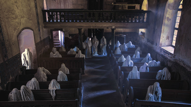 The figures represent the ghosts of Germans who lived in Lukova before World War II and who came to pray at this church every Sunday.