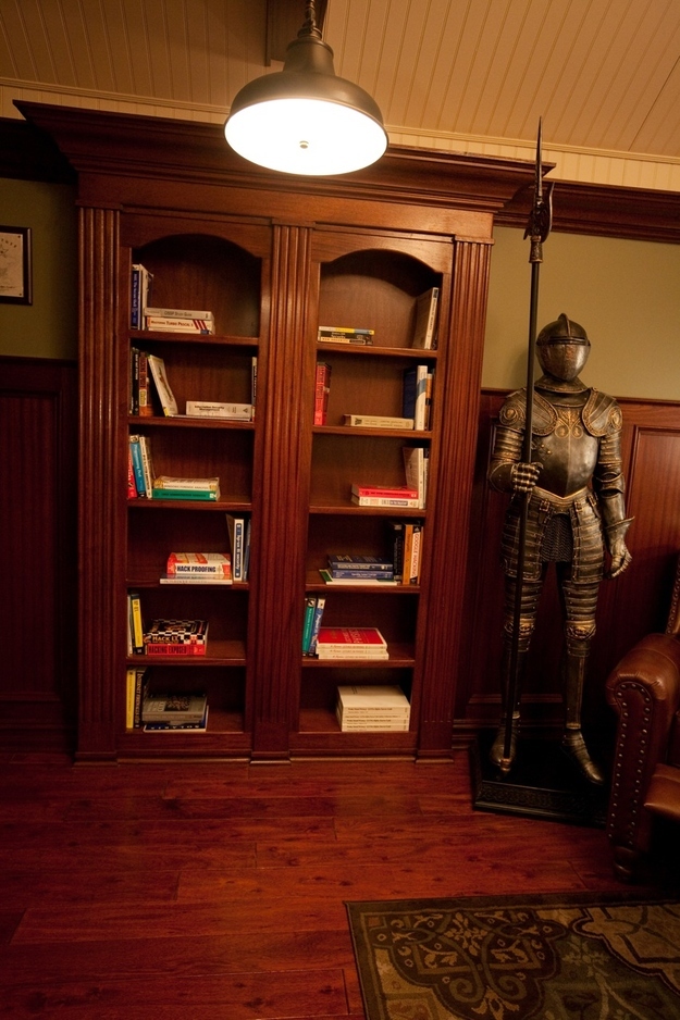 Home office hidden behind a gothic bookcase.