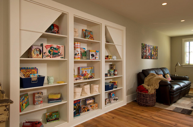 A hidden play room behind a toy shelf.