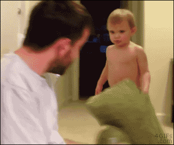 kid smothers his dad with a pillow gif